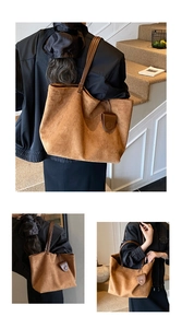 Macro view of large caramel brown suede tote bag showing texture and leather straps