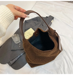 Close-up of deep brown faux fur tote bag with magnetic closure and leather strap