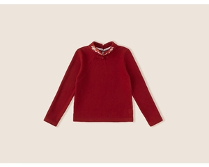 Detail of red Chinese style kid shirt with warm fleece lining and floral embroidery