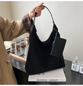Detail of black teddy faux fur tote bag with leather strap and detachable coin purse