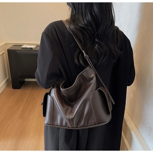 Detailed view of dark brown large capacity tote bag with side pocket and soft leather texture