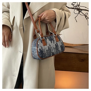 Mini denim Boston bag with silver sequins shown with a beige trench coat for a stylish look