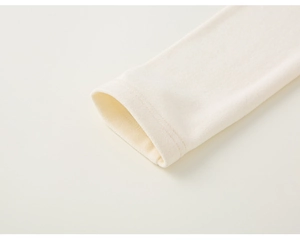 Close-up of beige quilted fabric sleeve with plush lining and reinforced stitching