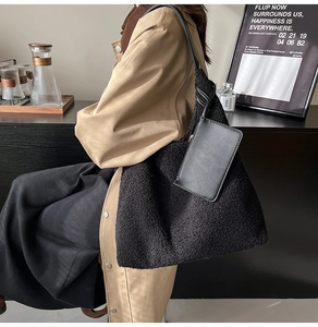 Detail of black faux fur tote bag with plush lamb wool texture and leather strap knots