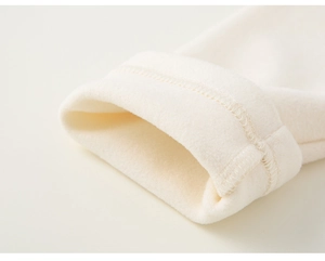 Detailed close-up of cream-colored plush fleece sleeve with fine double-stitch sewing