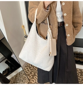 Detailed close-up of cream fuzzy fleece hobo bag with matching small zipper coin purse
