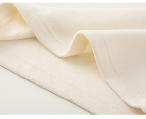 Close-up detail of cream embroidered fabric with soft fleece texture and fine stitching