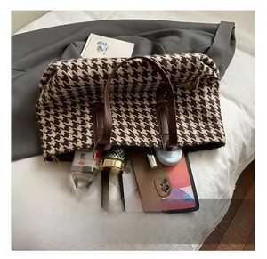 Detail showing the large interior capacity of this houndstooth tote bag for essentials