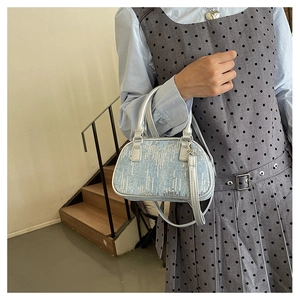 Detail of light blue sequin handbag with silver PU handles and adjustable strap
