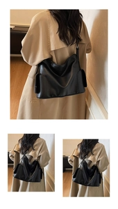 Detail of soft black leather tote bag shown on shoulder with side pocket accents