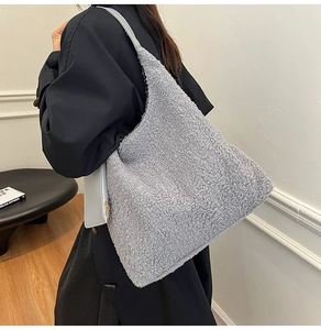 Detail of grey fuzzy lamb wool tote bag with matching coin purse on a shoulder strap