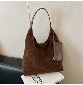 Detail of coffee fuzzy plush tote bag with brown leather strap and small side pouch