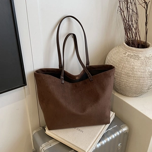Minimalist large capacity dark brown suede tote bag on silver suitcase with travel aesthetic