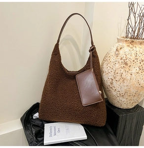 Detail of dark brown teddy fleece hobo bag with a matching pouch and knotted shoulder strap