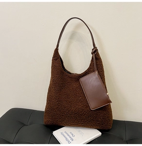 Detail view of brown teddy fleece hobo bag with leather strap and hanging mini card pouch