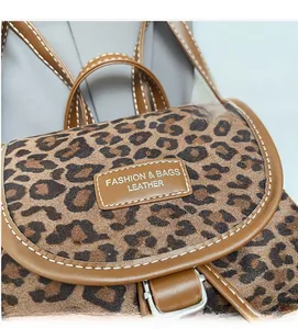 Détail du sac à dos léopard avec garniture en cuir marron et boucle en métal argenté