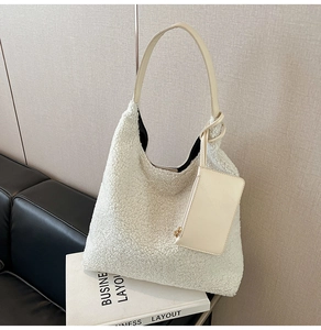 Detail of white faux fur tote bag with plush lamb hair texture and matching coin purse