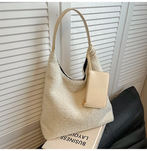 Detail of cream plush tote bag with smooth faux leather strap and matching small coin pouch