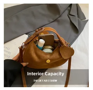 Detail of hobo bag interior showing space for phone and makeup with gold snap closure