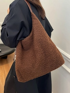 Brown sherpa tote bag with faux leather straps for winter commute and casual style