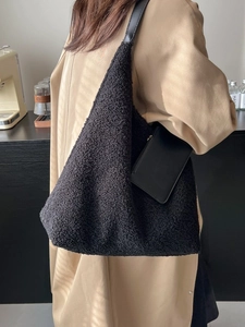 Fuzzy black fleece shoulder tote bag with small leather pouch for winter outfit