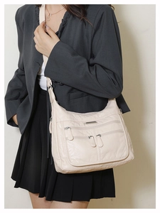 Detailed macro view of the multi-pocket soft faux leather crossbody bag with zippers