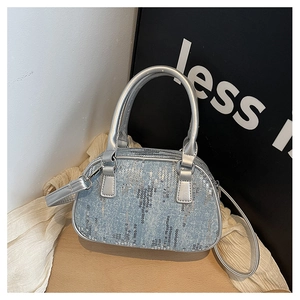 Detail of blue denim bowling bag with silver sequins and metallic top handles