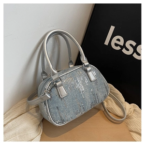 Detailed macro view of silver sequin stripes on light blue denim handbag texture