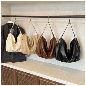 Detailed close-up showing four elegant hobo bags in cream, beige, brown and black colors