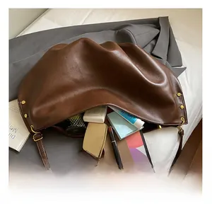 Macro view of spacious chocolate brown soft leather hobo bag showing large storage capacity