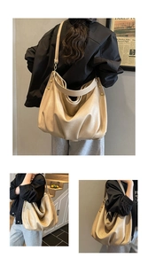 Detail view of large ruched leather tote bag with stylish metal studs and soft straps