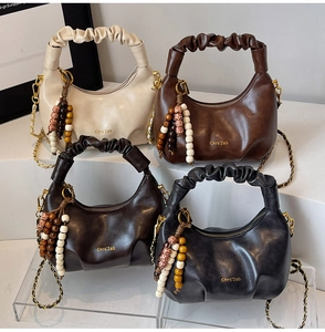 Selection of pleated dumpling bags in four colors with beaded charms and chain straps