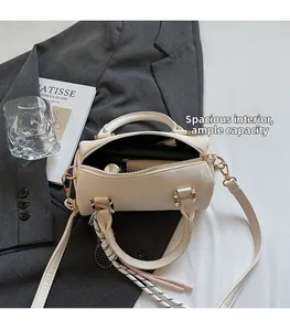 Detail shot of the spacious off-white Boston bag interior with various daily essentials