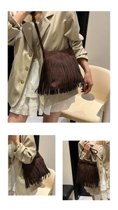 Detail of vintage brown suede shoulder bag featuring long fringe tassels and thin strap
