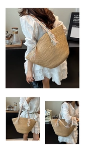 Detail of hand-woven straw tote bag featuring colorful braided straps and fringe tassels