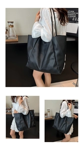 Detail of black large capacity tote bag featuring premium lychee grain leather texture
