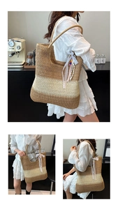 Macro shot of large straw tote bag with tricolor weave and white lace tassel charm