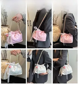 Detailed views of a quilted chain bucket bag with lace bow and pearl charms for women