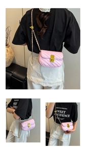 Detail view of pink quilted crossbody bag with golden chain strap and metal lock