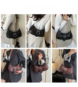 Detail showing vintage crescent underarm bags in black and rust red with belt buckle straps