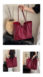 Detail of burgundy oversized tote bag in pebbled leather with secure magnetic closure