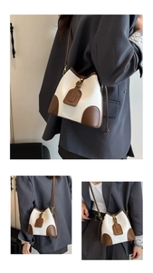 Detail of color-block bucket bag showing white lychee texture and brown leather accents