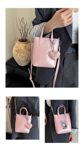 Detail view of pink crinkle effect mini bag with heart charm and transparent photo slot