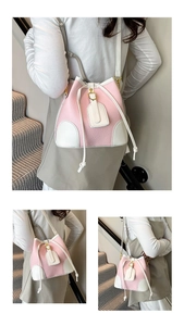 Detail of pink and white bucket bag with pebble leather texture and drawstring closure