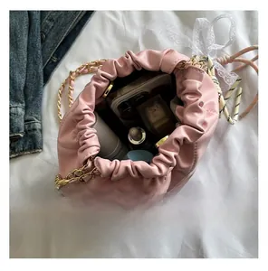 Pink quilted leather bucket bag showing internal capacity for phone and cosmetics