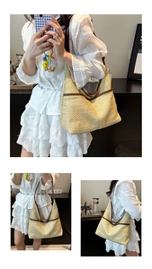 Detailed close-up of straw hobo bag with brown leather trim and shoulder strap details