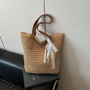 Handwoven straw tote bag with leather straps and lace bow decoration for summer