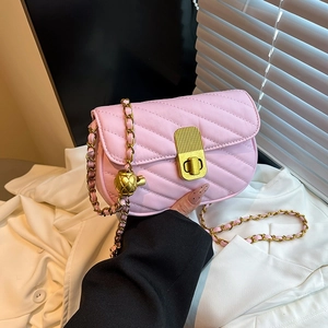Chic pink quilted chain crossbody bag with golden pineapple charm and turn-lock