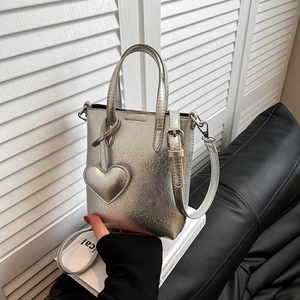 Chic silver metallic mini tote phone bag with heart pendant and adjustable strap