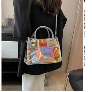 Detailed shot of laser holographic tote bag with metallic handles on stylish model